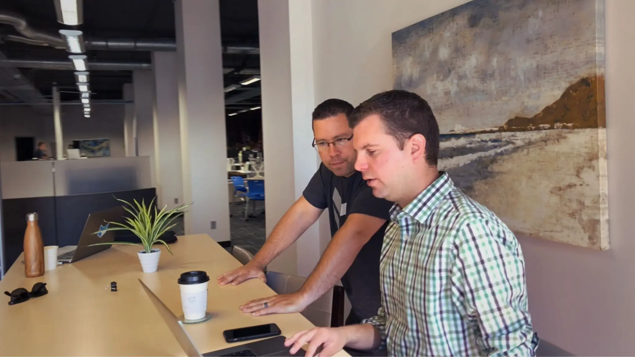 Two business operators reviewing a plan at a table